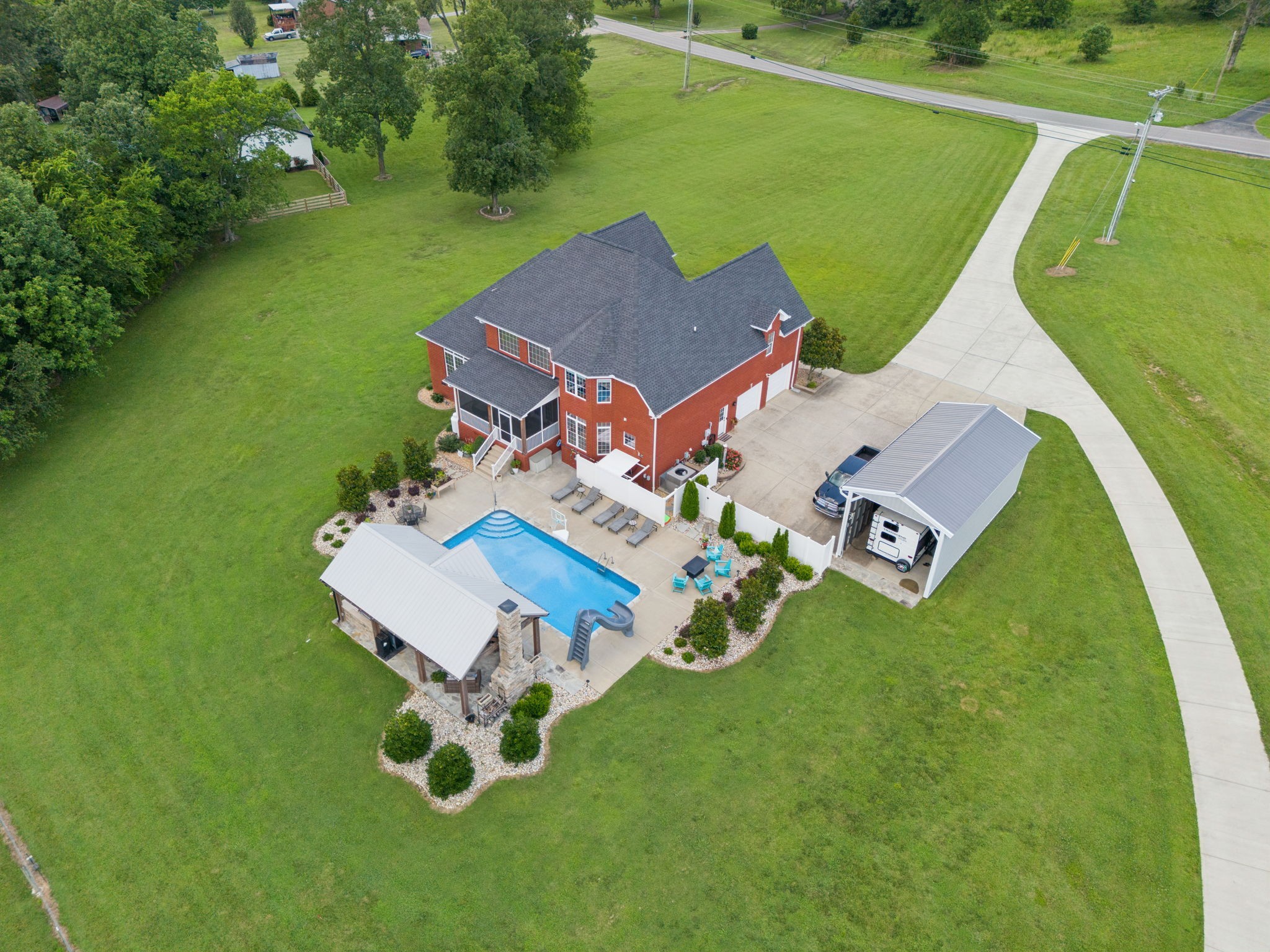 an aerial view of a house with a garden and trees