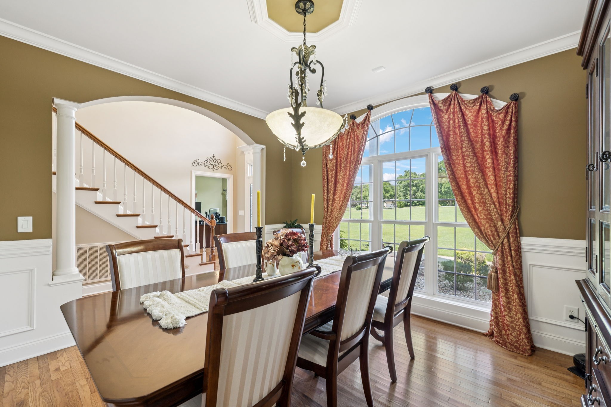 3056 Southeast Tater Peeler Road Lebanon, TN 37090 - Photo 16 of 100 a dining room with wooden floor a chandelier a wooden table and chairs