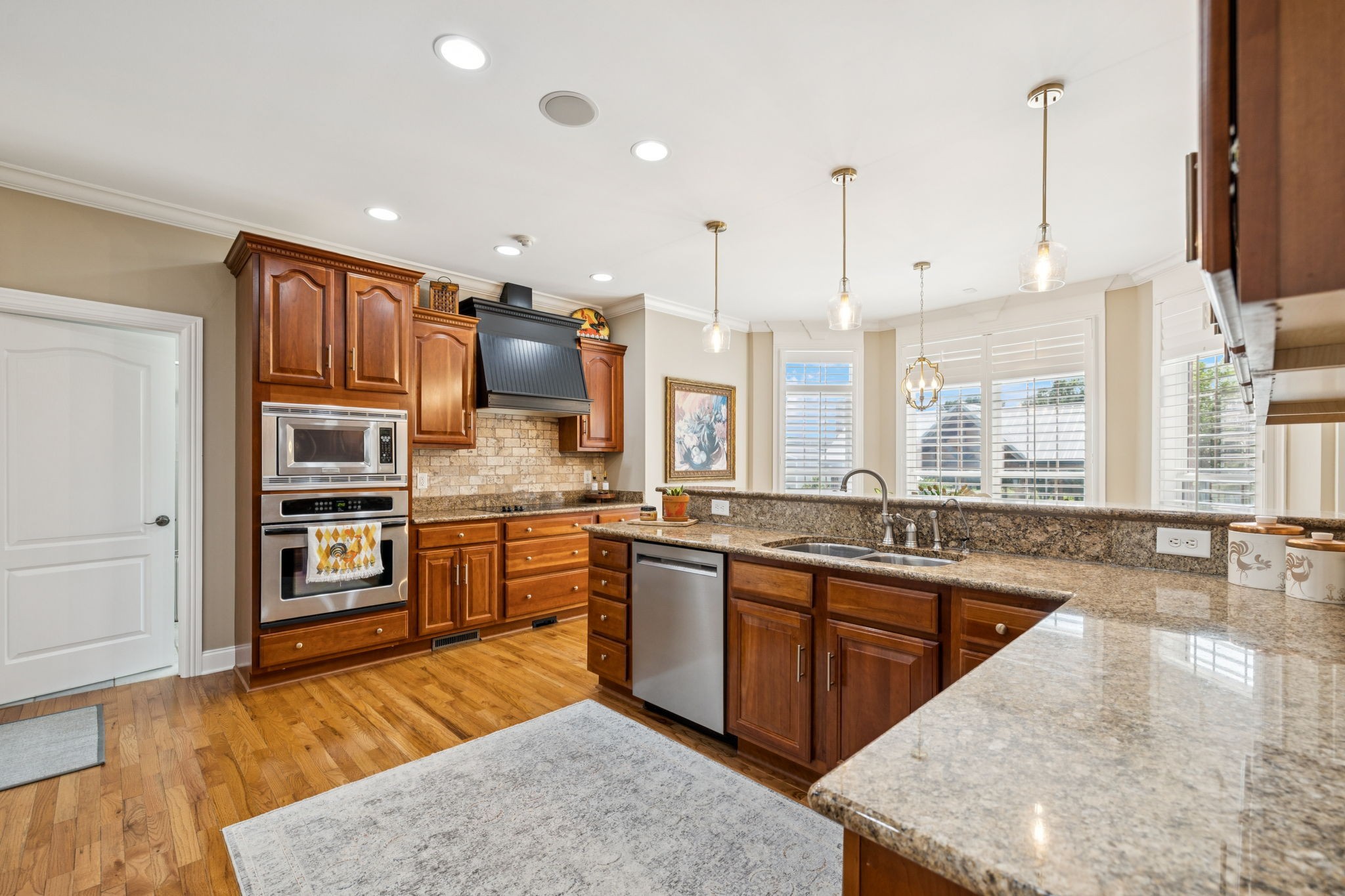 3056 Southeast Tater Peeler Road Lebanon, TN 37090 - Photo 34 of 100 a large kitchen with stainless steel appliances kitchen island granite countertop a sink and cabinets