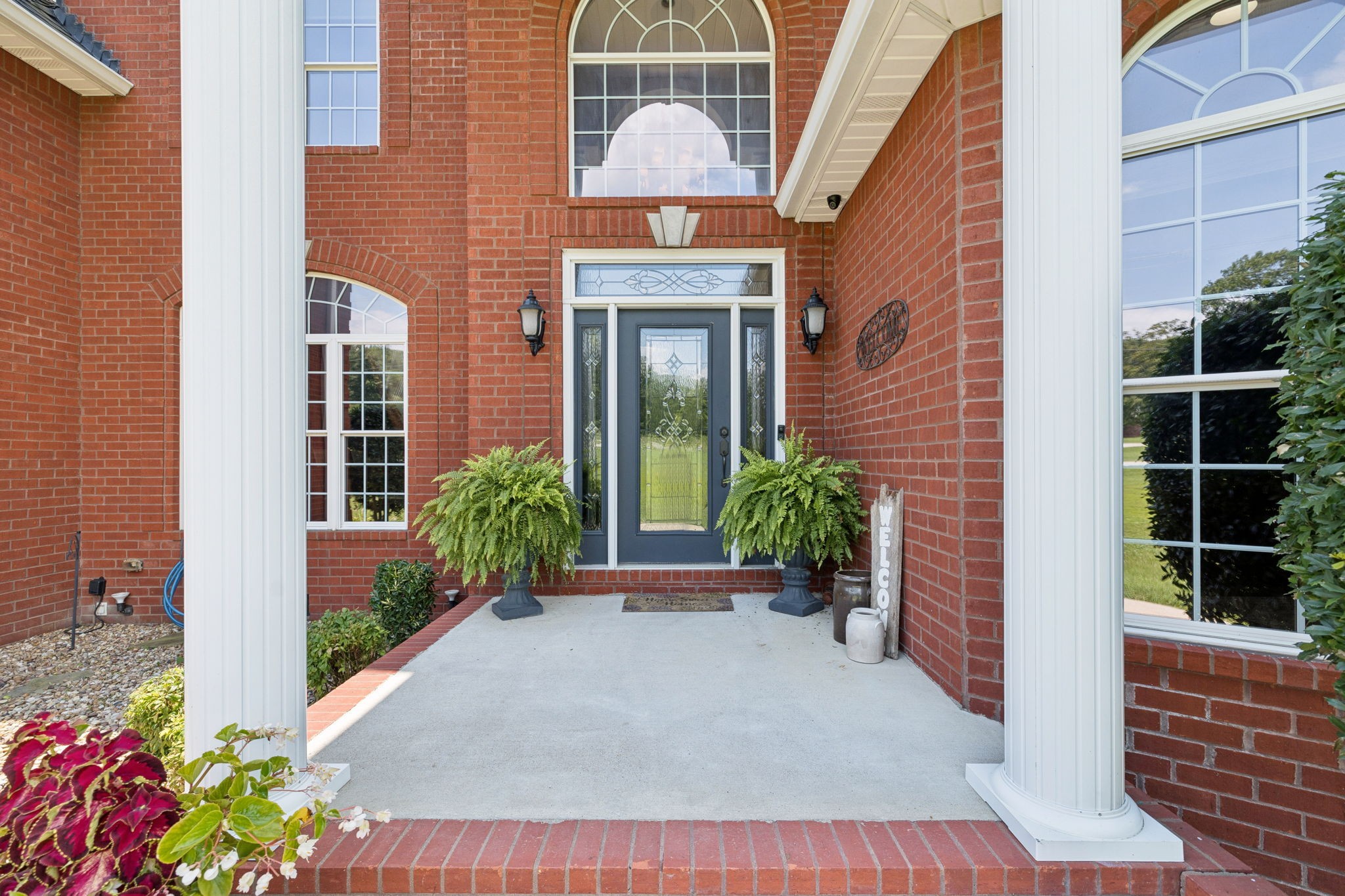 3056 Southeast Tater Peeler Road Lebanon, TN 37090 - Photo 5 of 100 a view of a brick house with potted plants