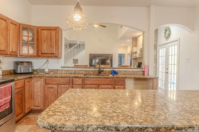 a large kitchen with kitchen island a large counter space a sink appliances and cabinets