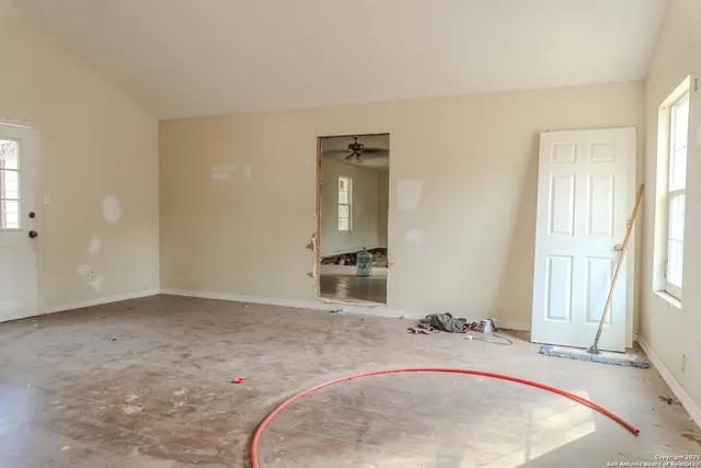 an entryway with wooden floor and mirror