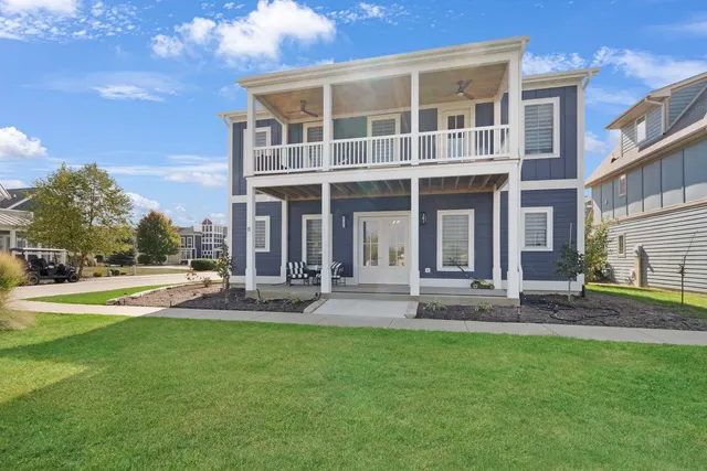 a view of a house with a yard and sitting area