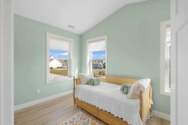 a bedroom with a bed and window