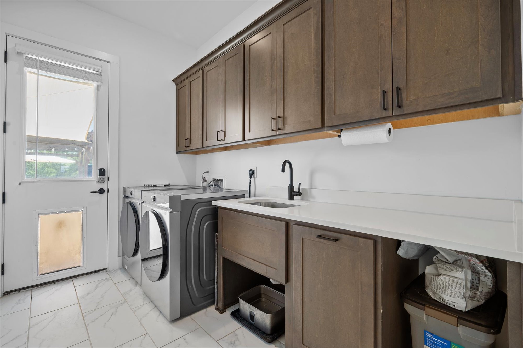 638 Strada Luca Florence, TX 76527 - Photo 10 of 38 Functional laundry room offers a built-in sink and ample storage with elegant cabinetry.