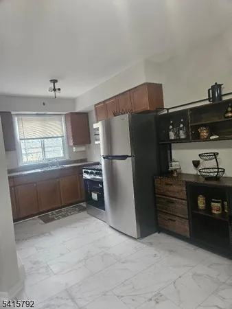 a kitchen with stainless steel appliances a refrigerator and a stove
