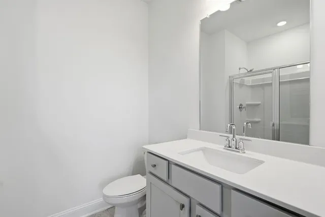 a bathroom with a sink toilet and a mirror