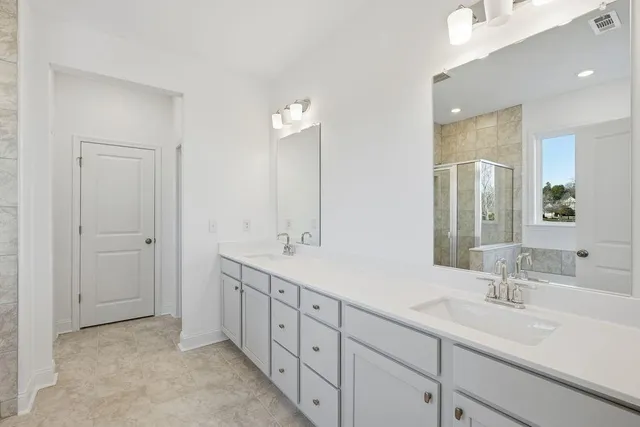 a bathroom with 2 sink tub and a mirror