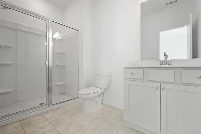 a bathroom with a toilet a sink and shower