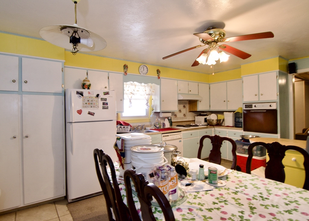 156 Allen Street Springfield, MA 01108 - Photo 13 of 31 a kitchen with stainless steel appliances kitchen island granite countertop a refrigerator a sink a stove and white cabinets with wooden floor