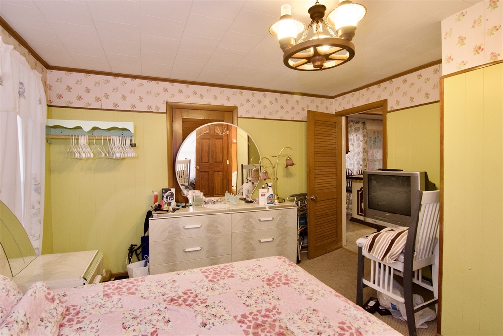 156 Allen Street Springfield, MA 01108 - Photo 17 of 31 a bedroom with a bed and wooden floor