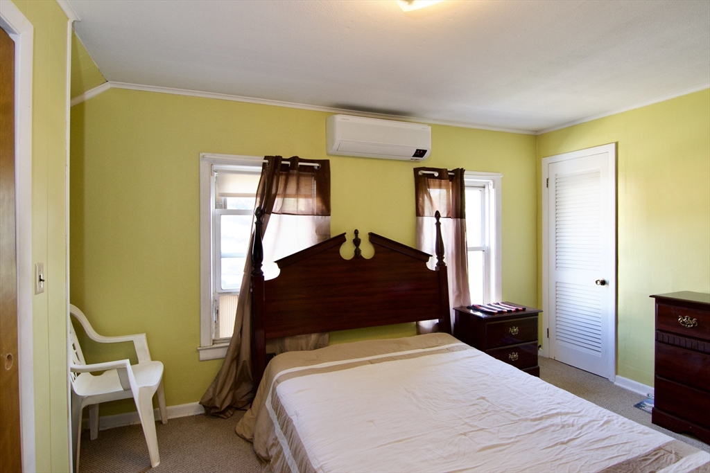 156 Allen Street Springfield, MA 01108 - Photo 22 of 31 a bedroom with a bed and wooden floor