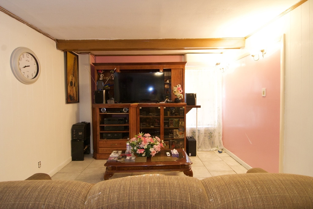 156 Allen Street Springfield, MA 01108 - Photo 9 of 31 a bedroom with furniture and a flat screen tv