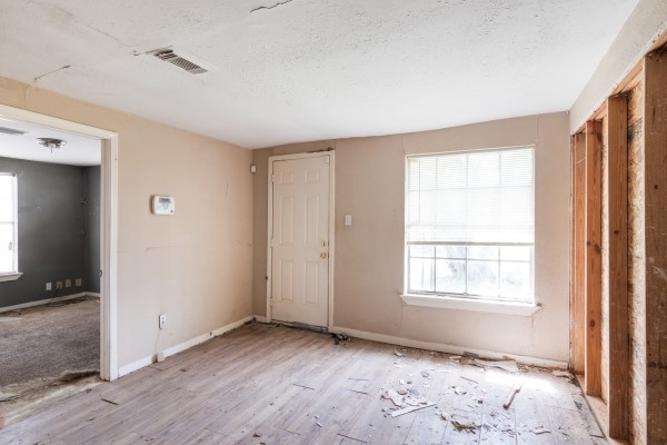 7973 Ritz Street Houston, TX 77028 - Photo 11 of 21 a view of an empty room with wooden floor and a window