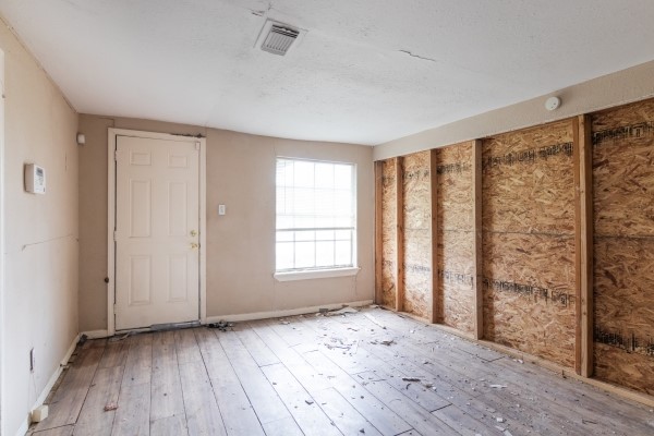 7973 Ritz Street Houston, TX 77028 - Photo 16 of 21 wooden floor in an empty room with a window