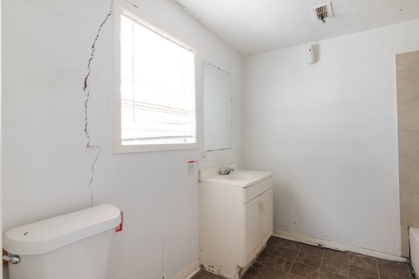 7973 Ritz Street Houston, TX 77028 - Photo 19 of 21 a bathroom with a toilet sink and mirror