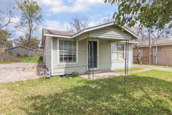 7973 Ritz Street Houston, TX 77028 - Photo 3 of 21 a front view of a house with a yard