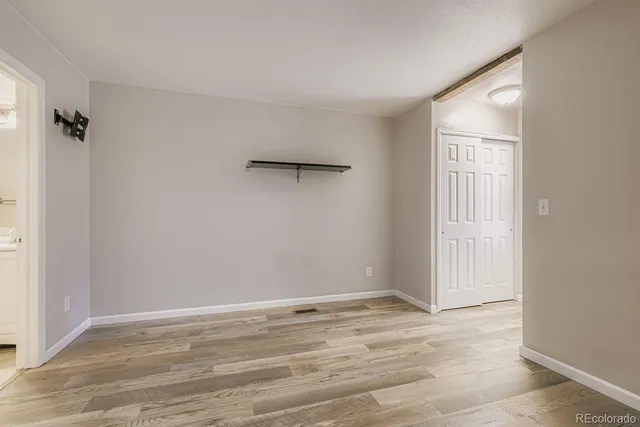 a view of a room with wooden floor and bathroom