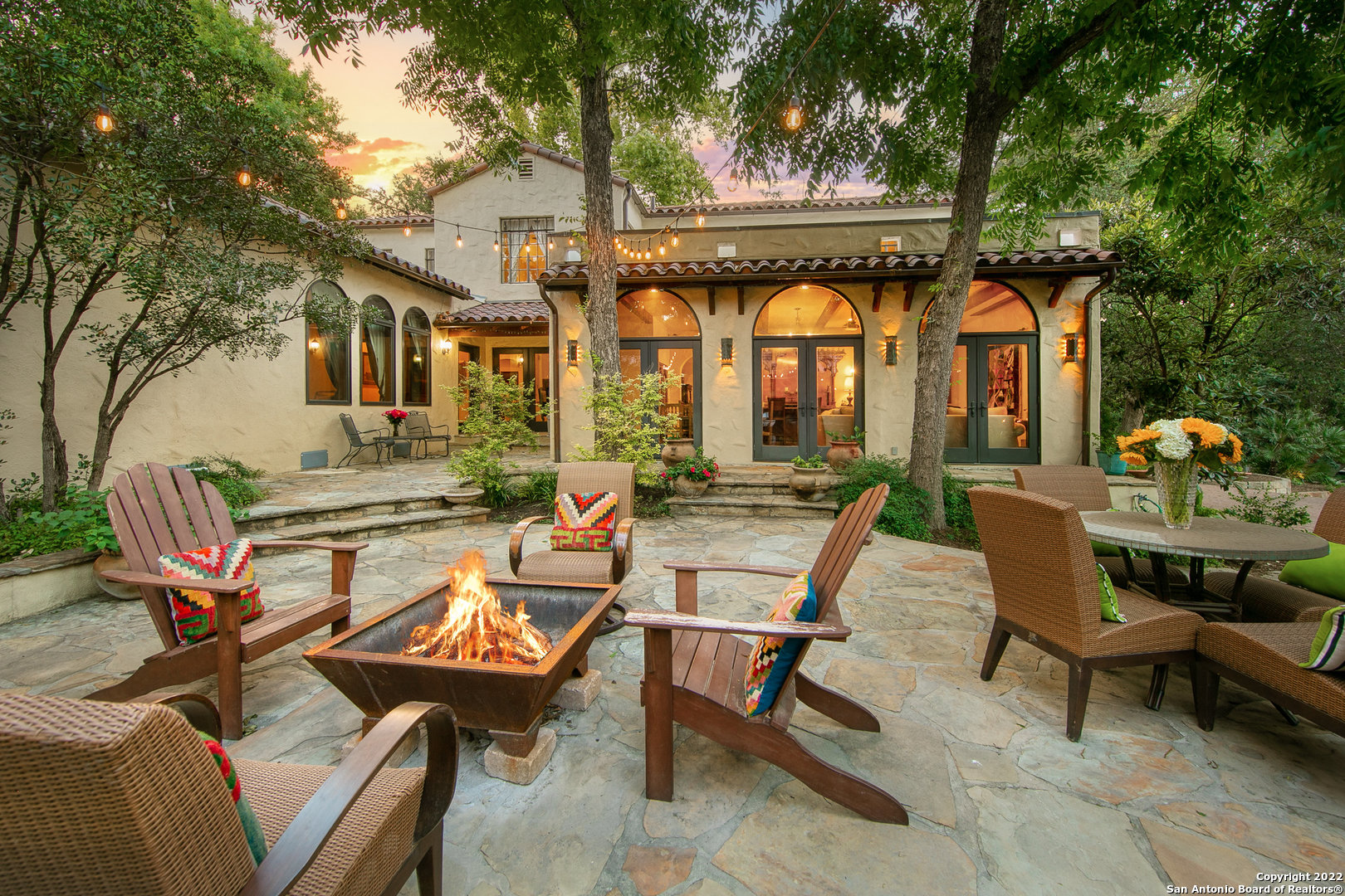 a backyard of a house with outdoor seating