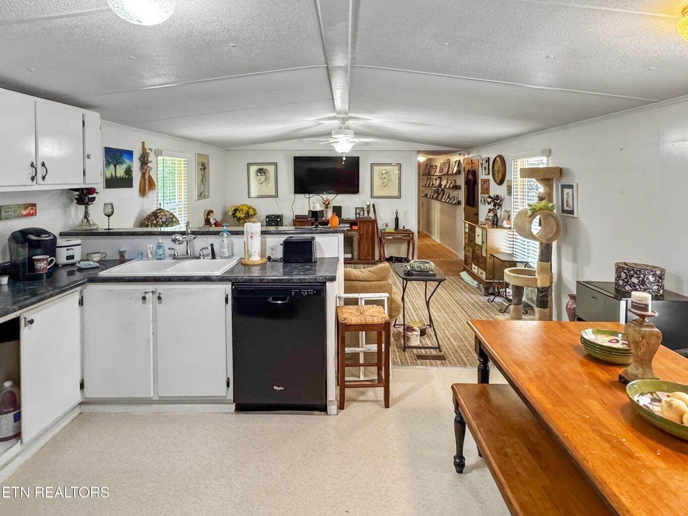160 Casey Road Harriman, TN 37748 - Photo 14 of 30 a kitchen with stainless steel appliances granite countertop a stove top oven a sink dishwasher and white cabinets with wooden floor