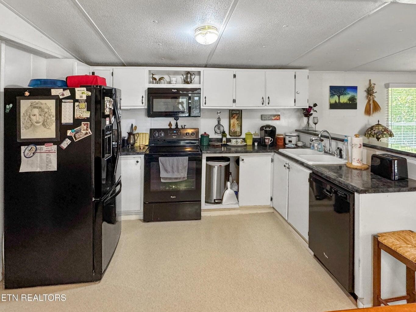 160 Casey Road Harriman, TN 37748 - Photo 7 of 30 a kitchen with kitchen island a sink cabinets and stainless steel appliances