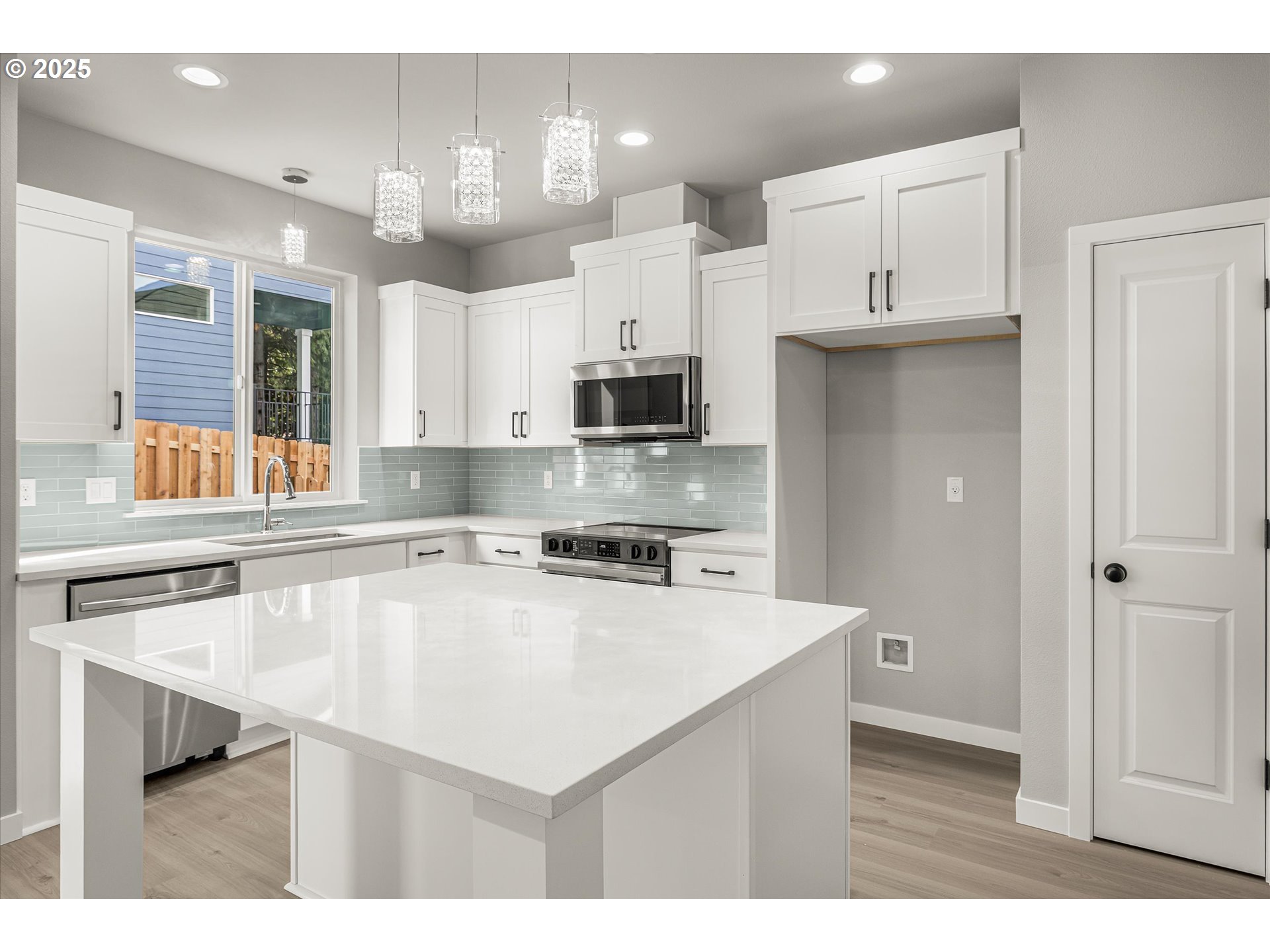 296 Southwest Mawrcrest Avenue Gresham, OR 97030 - Photo 12 of 35 a kitchen with kitchen island a sink counter top space appliances and cabinets