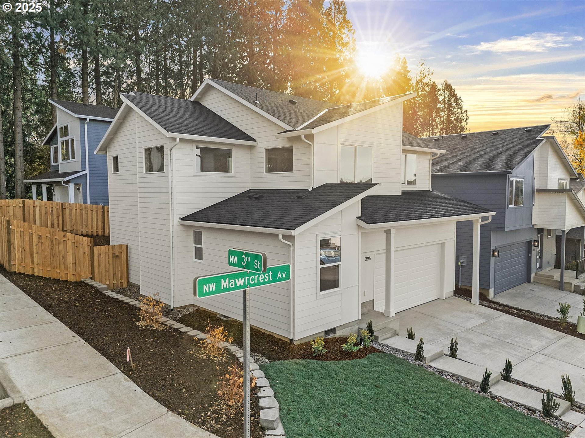 296 Southwest Mawrcrest Avenue Gresham, OR 97030 - Photo 2 of 35 a view of a white house next to a yard with wooden fence