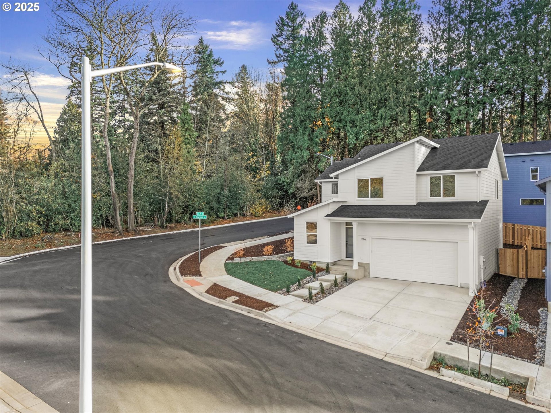 296 Southwest Mawrcrest Avenue Gresham, OR 97030 - Photo 3 of 35 a white house with a large tree and wooden fence