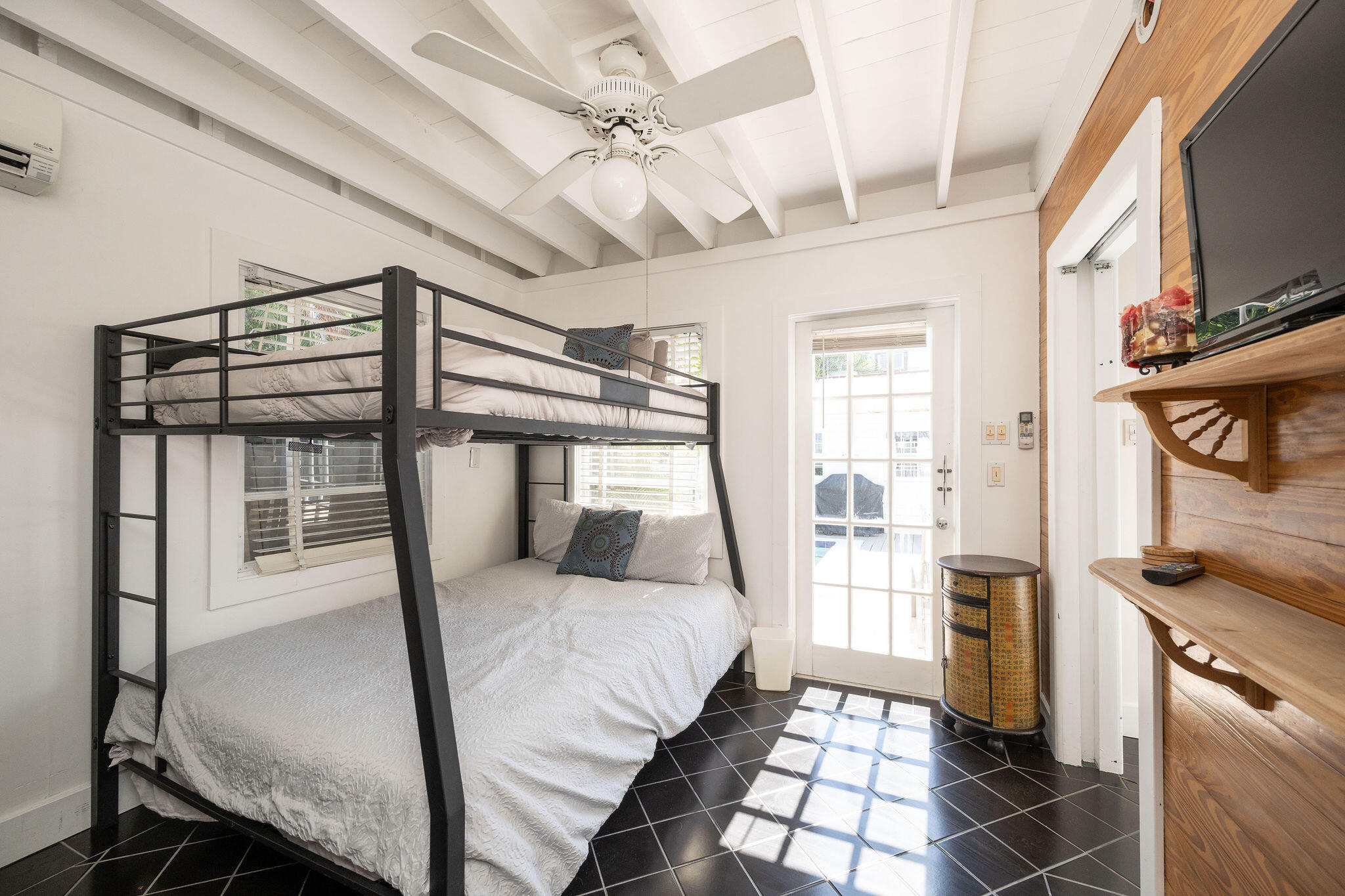 912 James Street, Unit 2 Key West, FL 33040 - Photo 17 of 25 a bedroom with a bed next to a window with the outer view