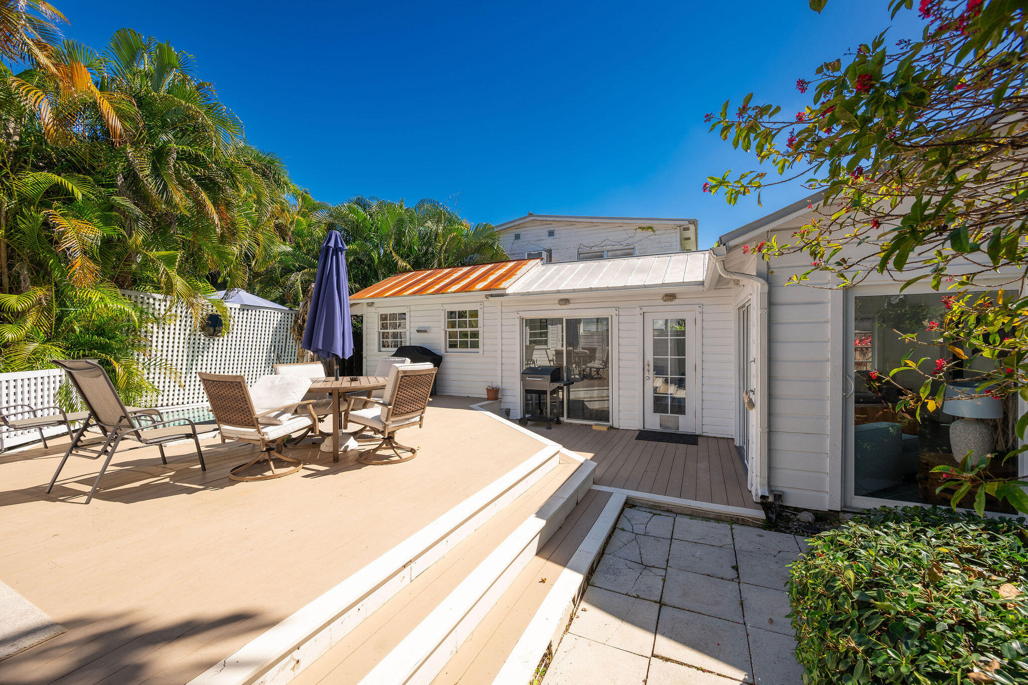 912 James Street, Unit 2 Key West, FL 33040 - Photo 4 of 25 a view of a patio with table and chairs under an umbrella with potted plants