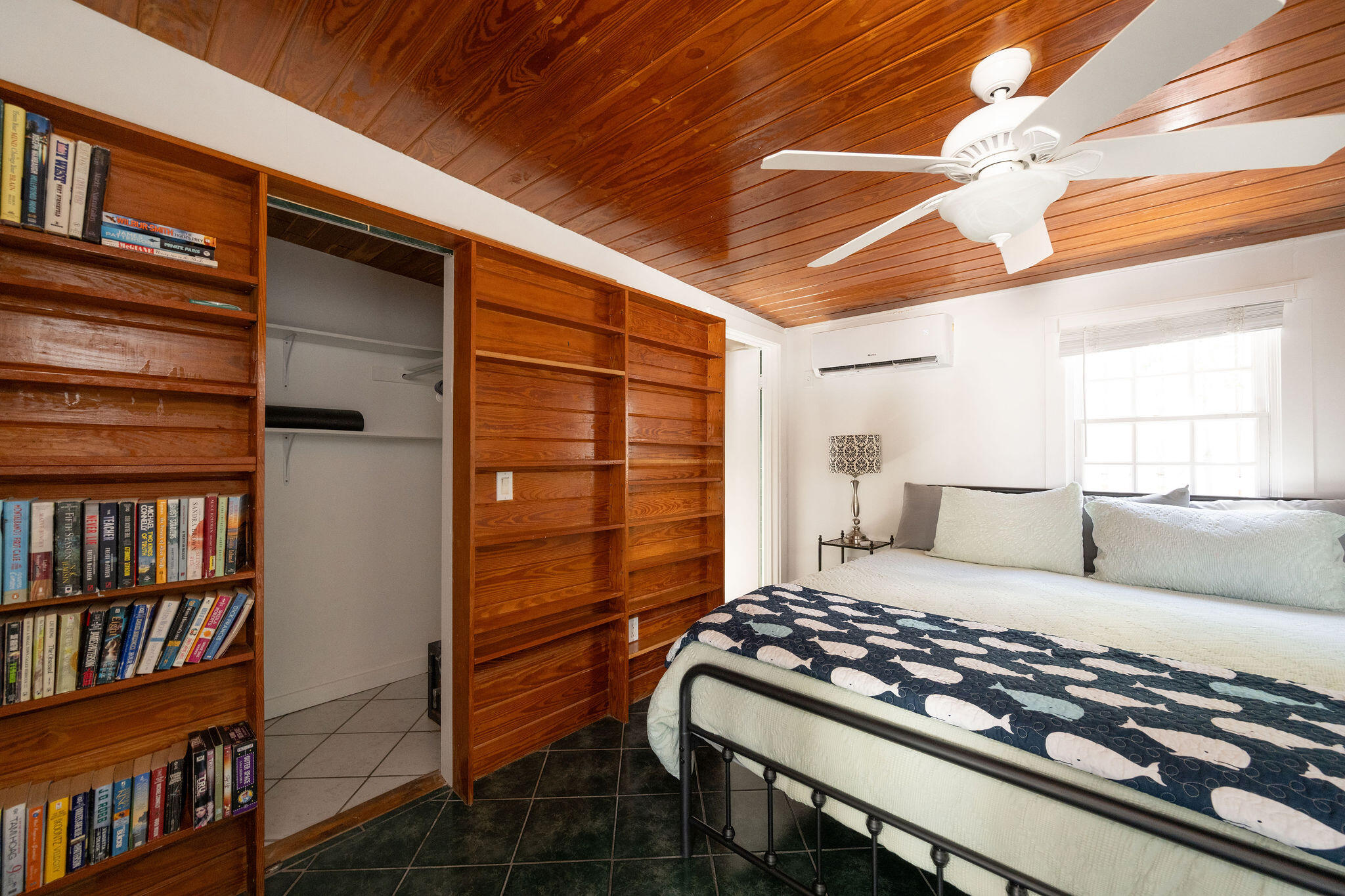 912 James Street, Unit 2 Key West, FL 33040 - Photo 10 of 25 a bedroom with a bed and a book shelf