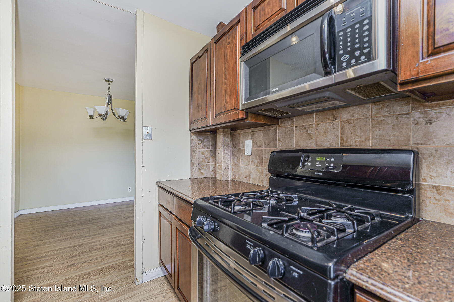 1100 Clove Road, Unit 60 Staten Island, NY 10301 - Photo 16 of 25 a stove top oven sitting inside of a kitchen