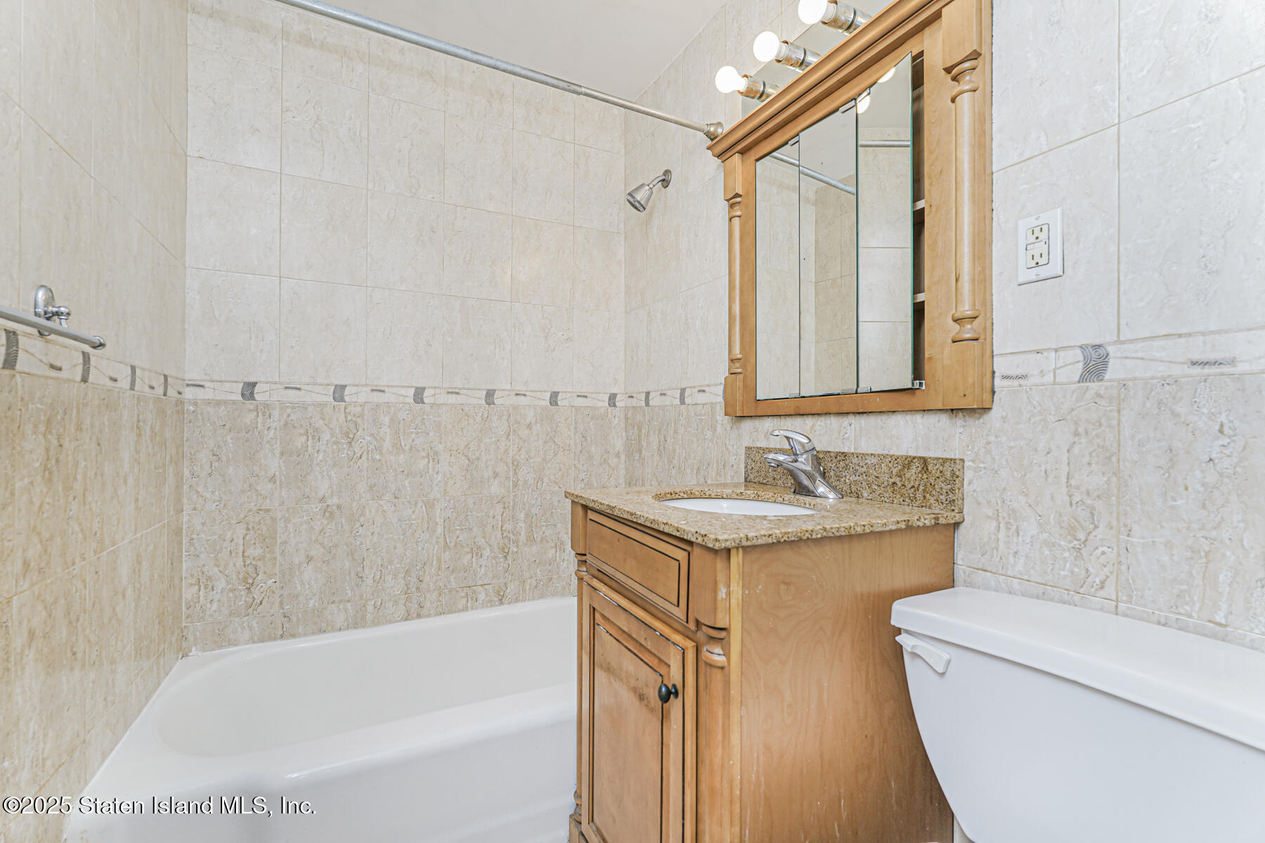 1100 Clove Road, Unit 60 Staten Island, NY 10301 - Photo 17 of 25 a bathroom with a granite countertop sink toilet and shower