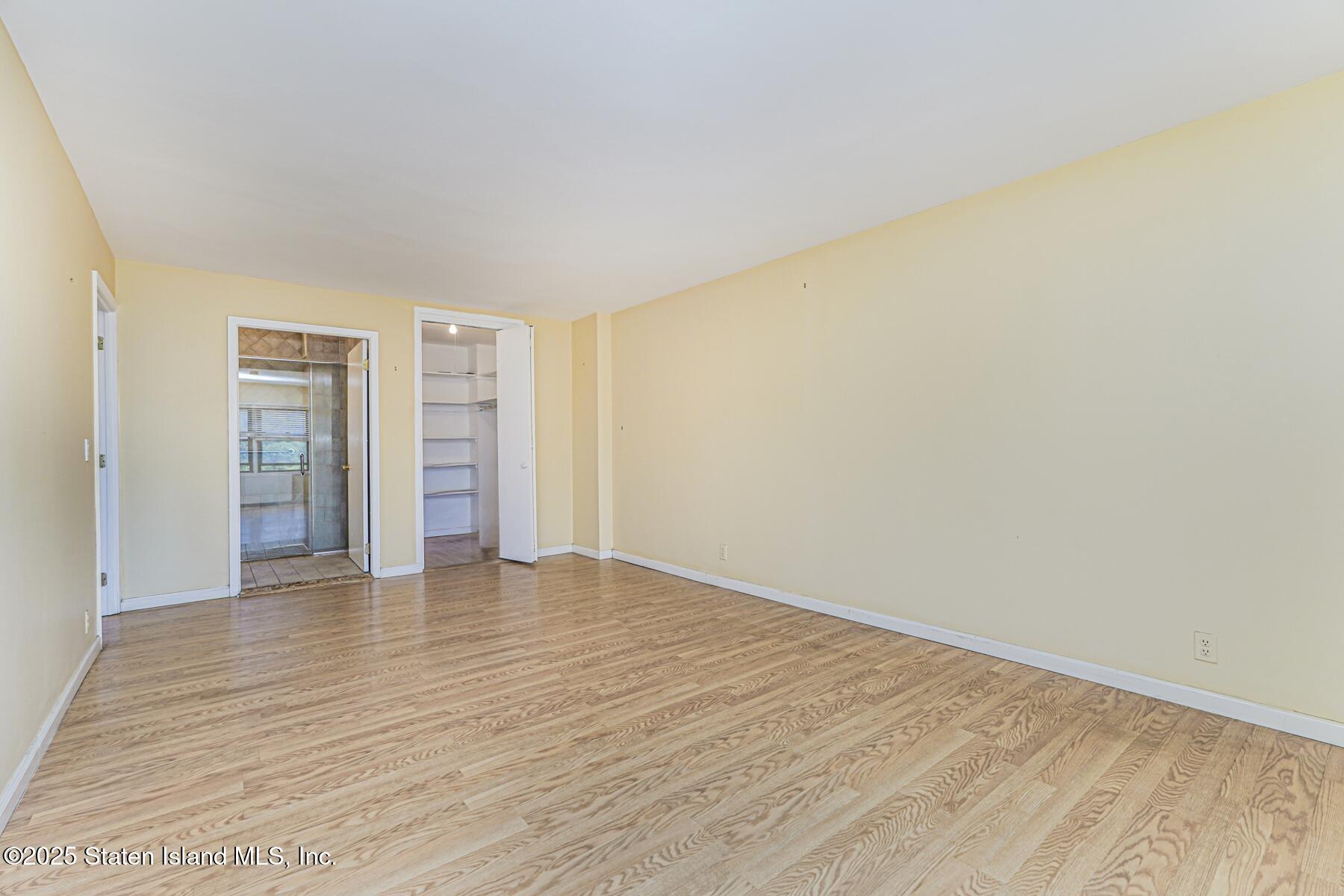 1100 Clove Road, Unit 60 Staten Island, NY 10301 - Photo 18 of 25 a view of an empty room with wooden floor