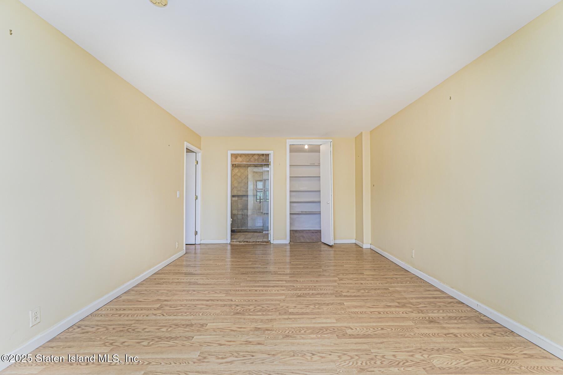 1100 Clove Road, Unit 60 Staten Island, NY 10301 - Photo 19 of 25 a view of an empty room with wooden floor