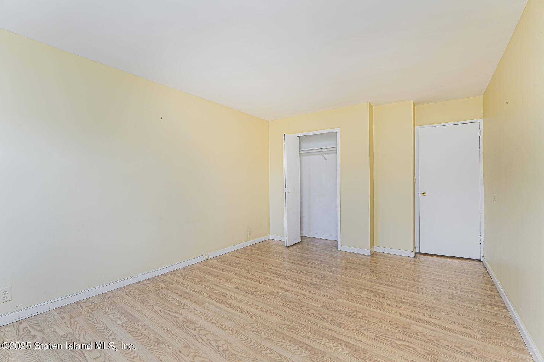 1100 Clove Road, Unit 60 Staten Island, NY 10301 - Photo 20 of 25 a view of an empty room and wooden floor
