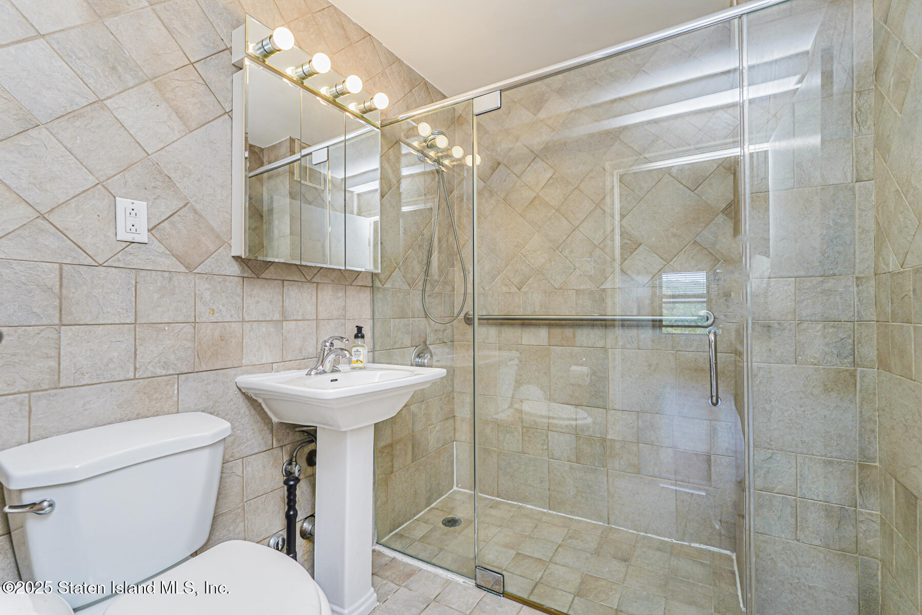 1100 Clove Road, Unit 60 Staten Island, NY 10301 - Photo 22 of 25 a bathroom with a sink toilet and shower