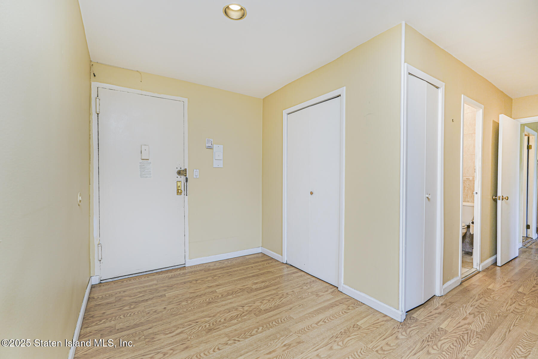 1100 Clove Road, Unit 60 Staten Island, NY 10301 - Photo 4 of 25 a view of an empty room with wooden floor and a window