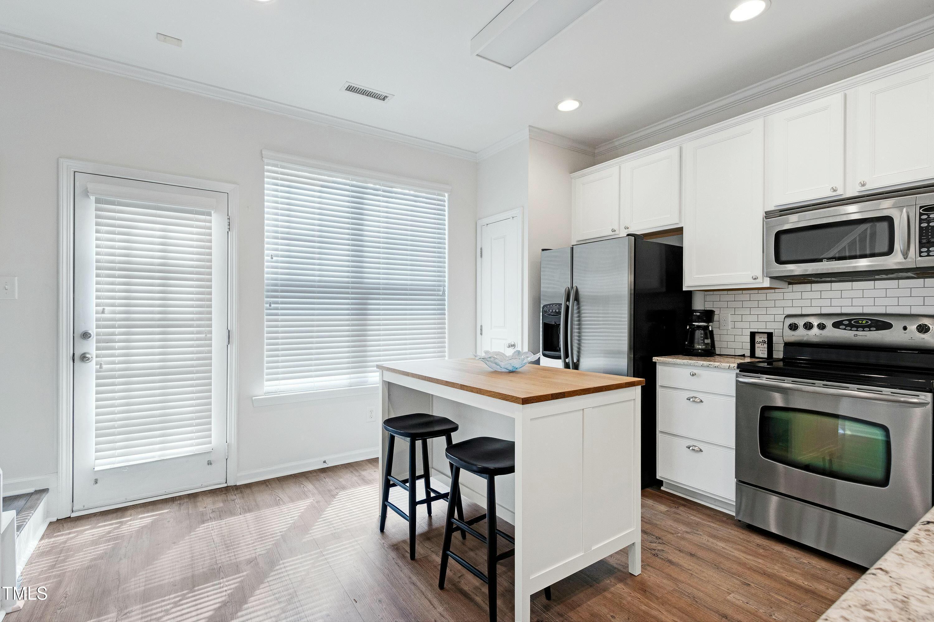 4835 Sir Duncan Way Raleigh, NC 27612 - Photo 11 of 30 a kitchen with a stove a sink and a refrigerator