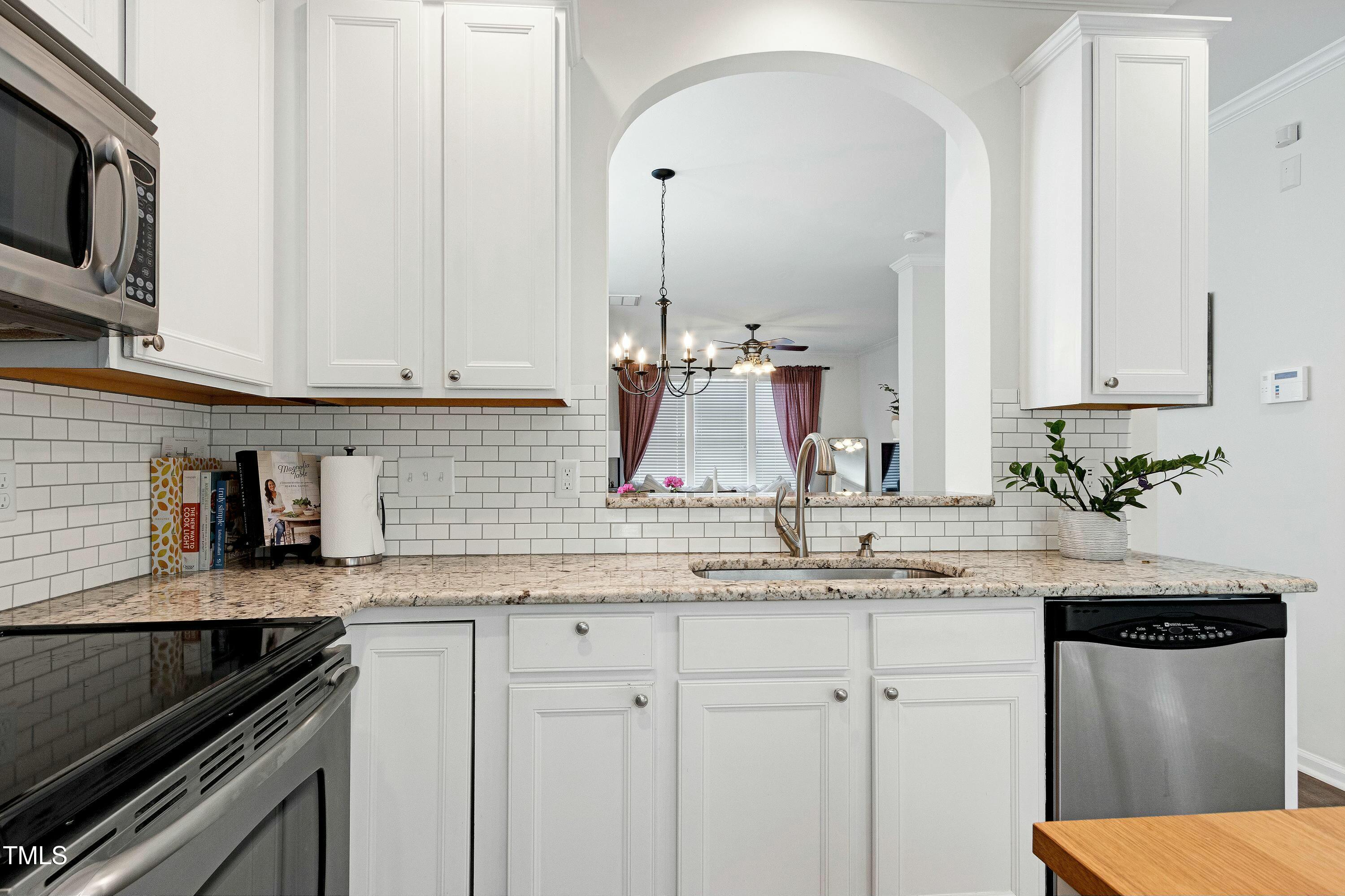 4835 Sir Duncan Way Raleigh, NC 27612 - Photo 13 of 30 a kitchen with stainless steel appliances granite countertop a sink stove and cabinets