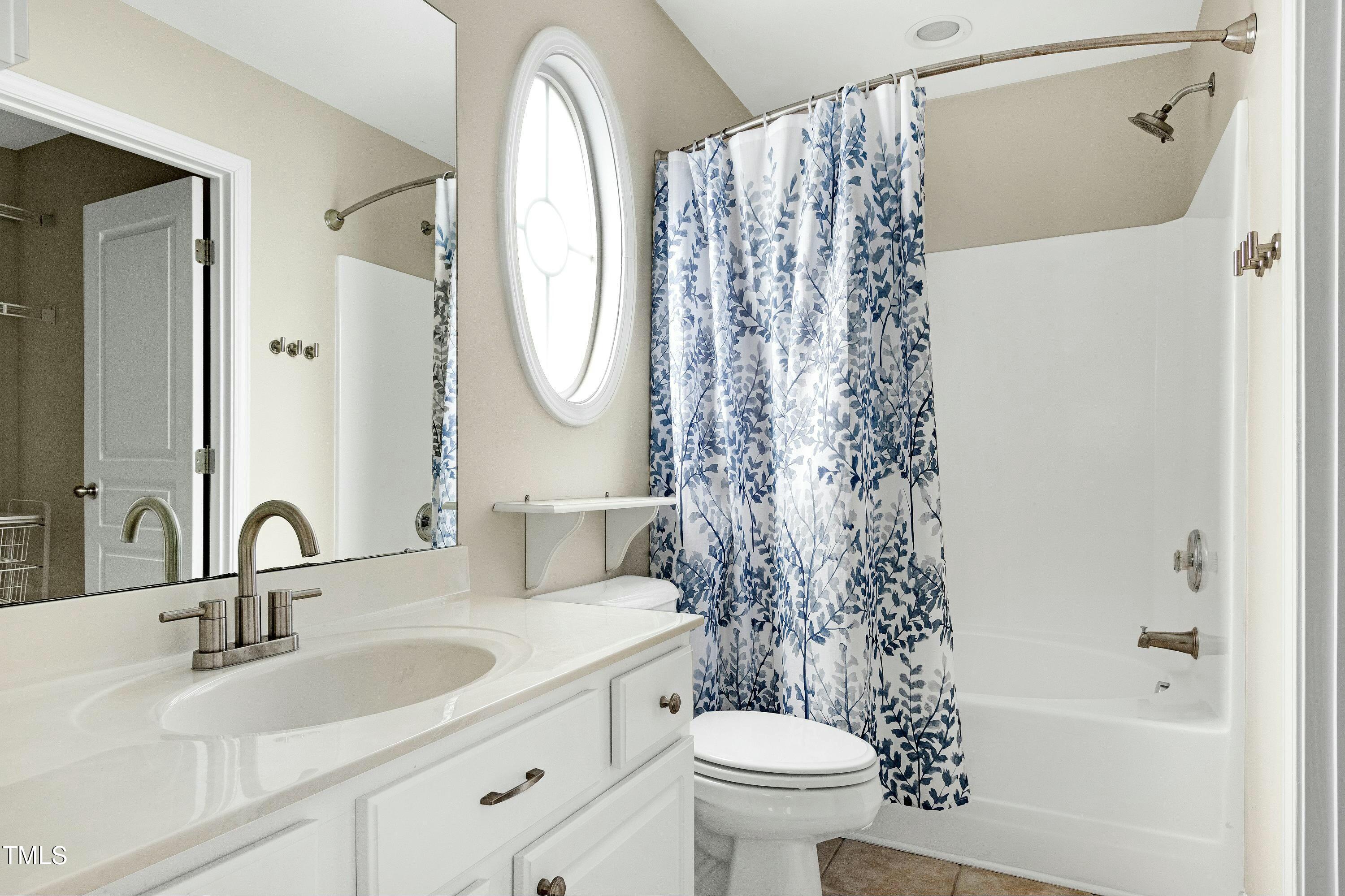 4835 Sir Duncan Way Raleigh, NC 27612 - Photo 17 of 30 a bathroom with a sink a toilet and a mirror