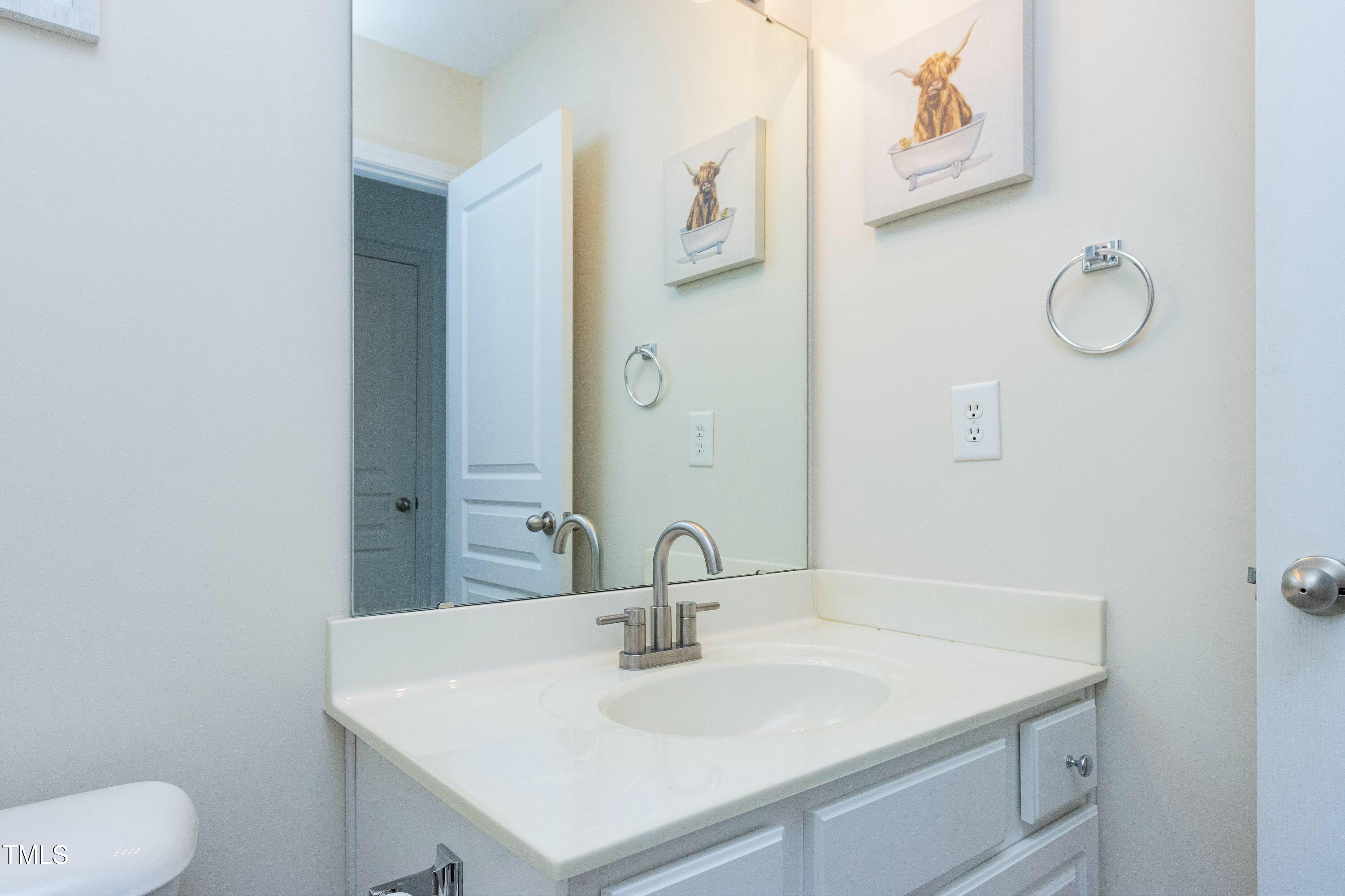 4835 Sir Duncan Way Raleigh, NC 27612 - Photo 23 of 30 a close view of a sink and a mirror in a bathroom