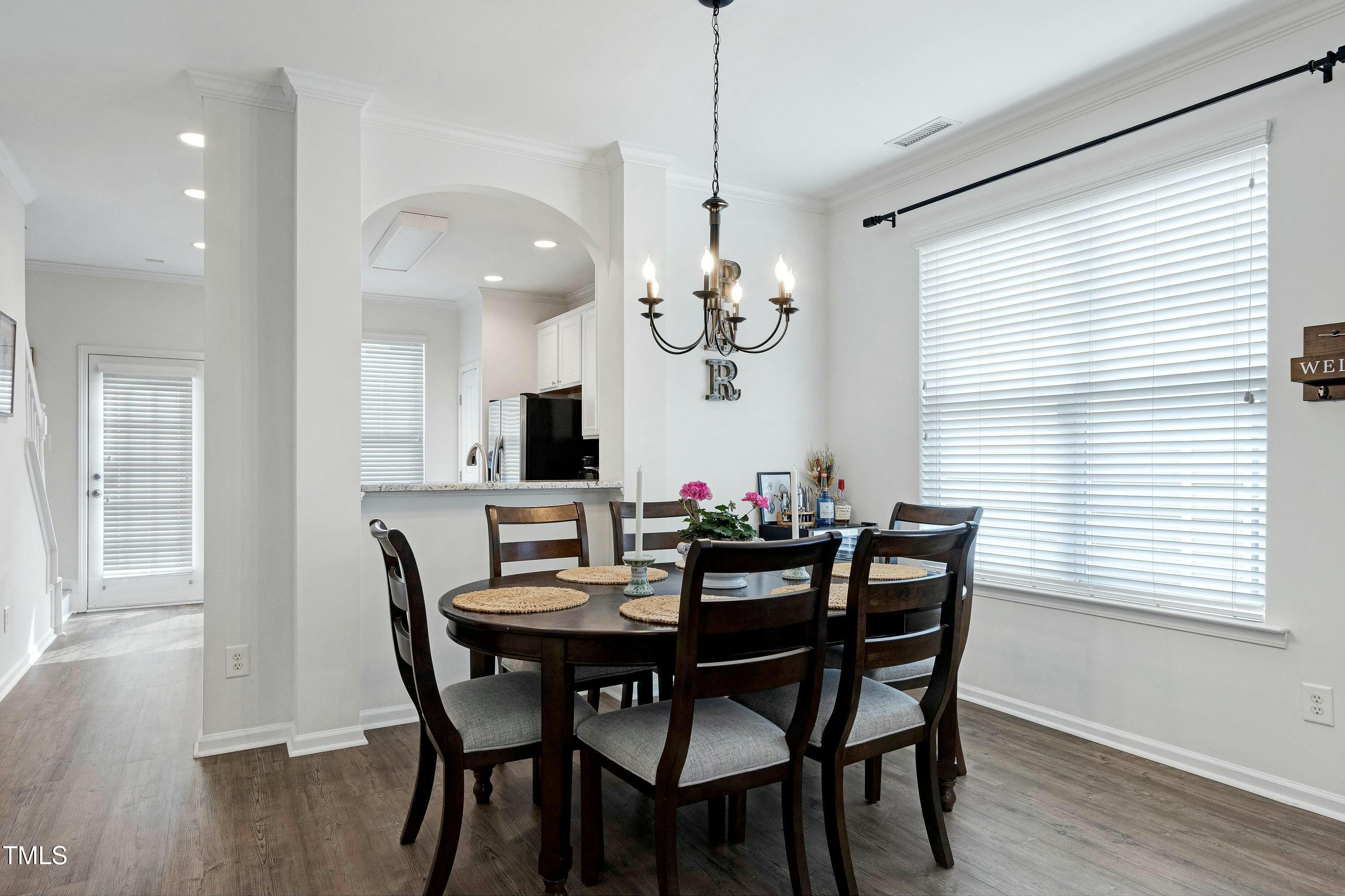 4835 Sir Duncan Way Raleigh, NC 27612 - Photo 8 of 30 a view of a dining room with furniture and chandelier