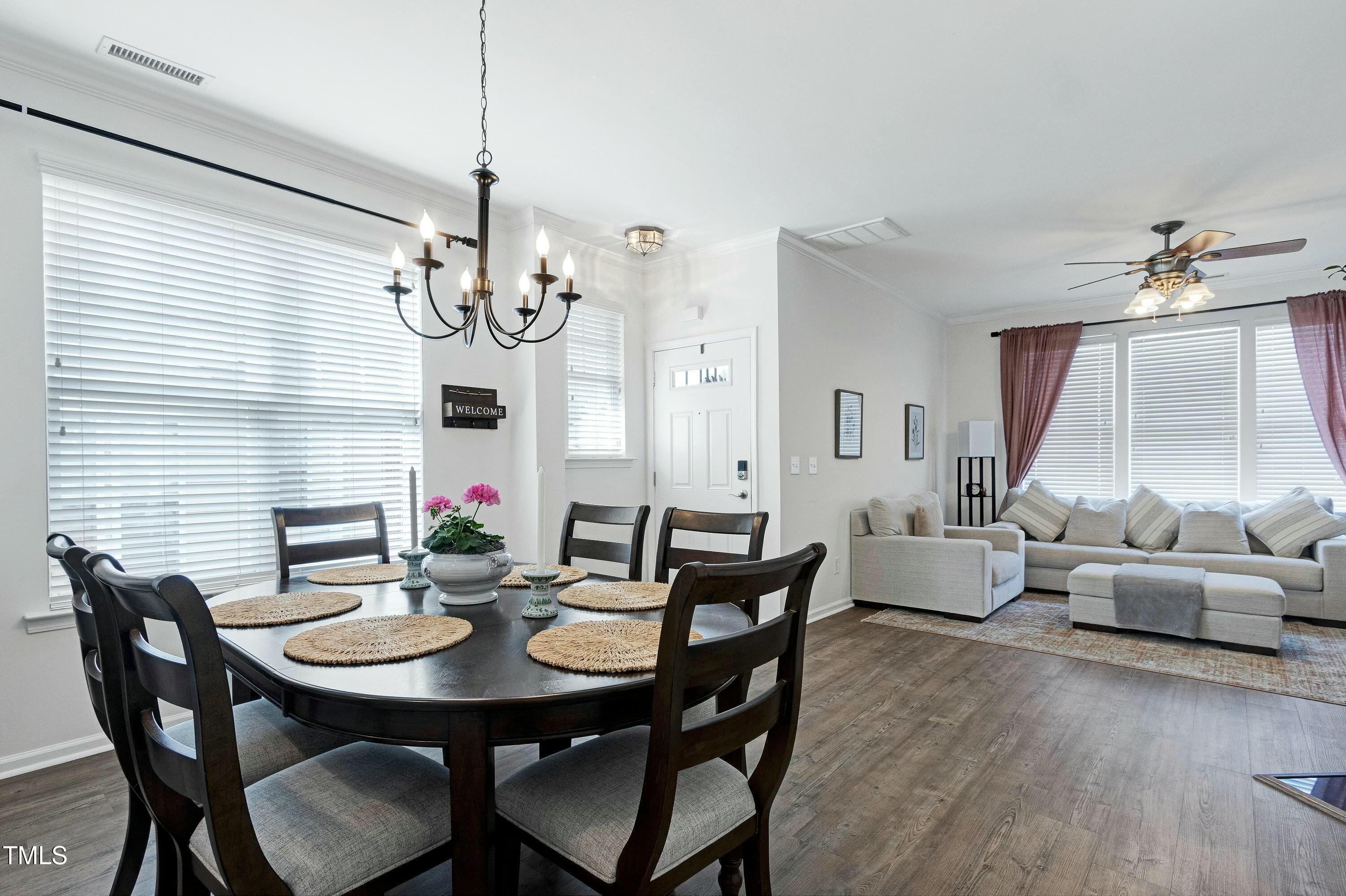 4835 Sir Duncan Way Raleigh, NC 27612 - Photo 9 of 30 a view of a dining room with furniture window and wooden floor