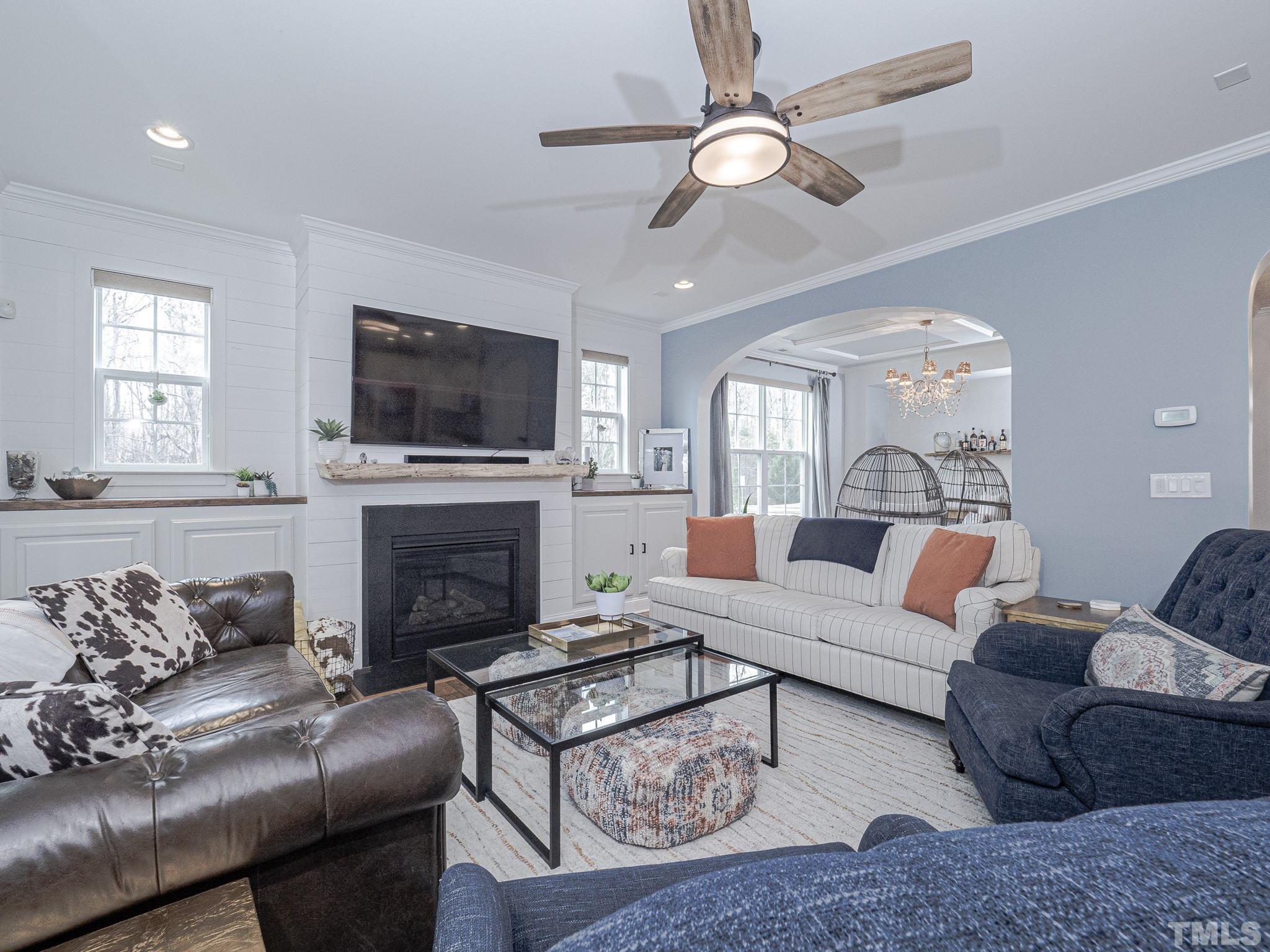 1990 Mostyn Lane Apex, NC 27502 - Photo 11 of 41 a living room with furniture a fireplace and a flat screen tv
