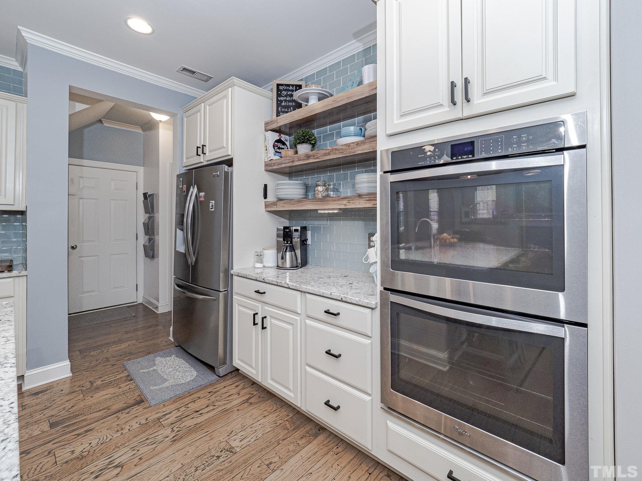 1990 Mostyn Lane Apex, NC 27502 - Photo 15 of 41 a kitchen with stainless steel appliances granite countertop a refrigerator and a stove top oven