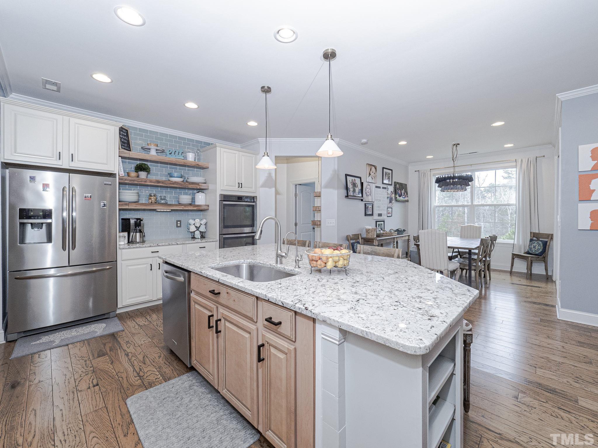 1990 Mostyn Lane Apex, NC 27502 - Photo 17 of 41 a kitchen with stainless steel appliances granite countertop a sink a refrigerator and a stove