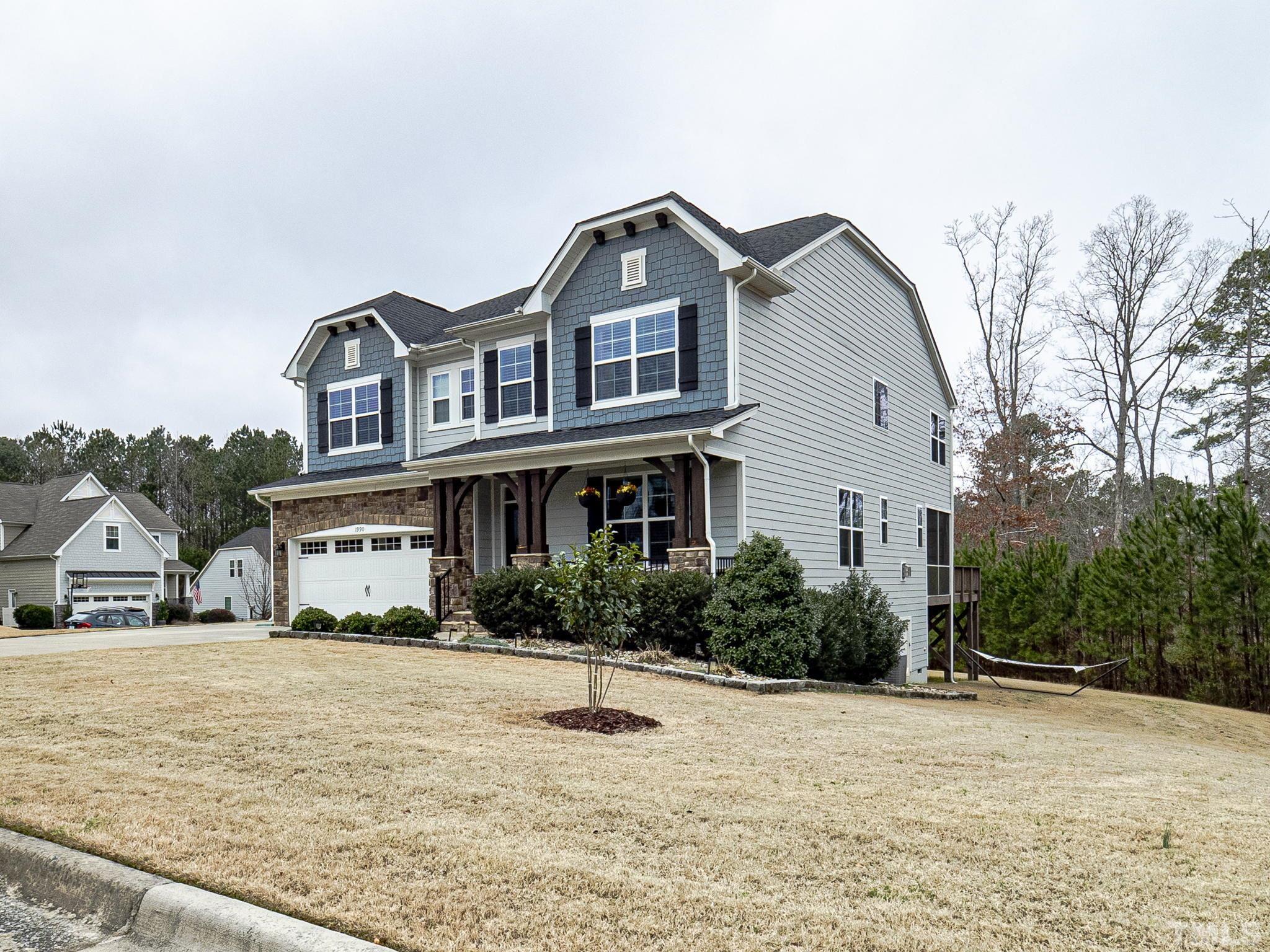 1990 Mostyn Lane Apex, NC 27502 - Photo 2 of 41 a front view of a house with a yard