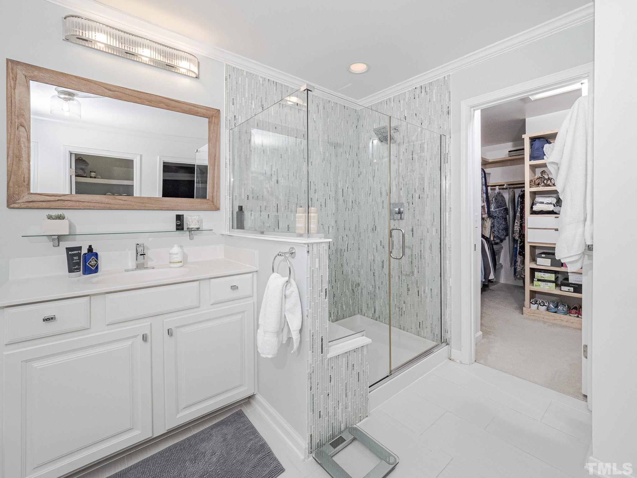 1990 Mostyn Lane Apex, NC 27502 - Photo 27 of 41 a spacious bathroom with a shower sink and mirror