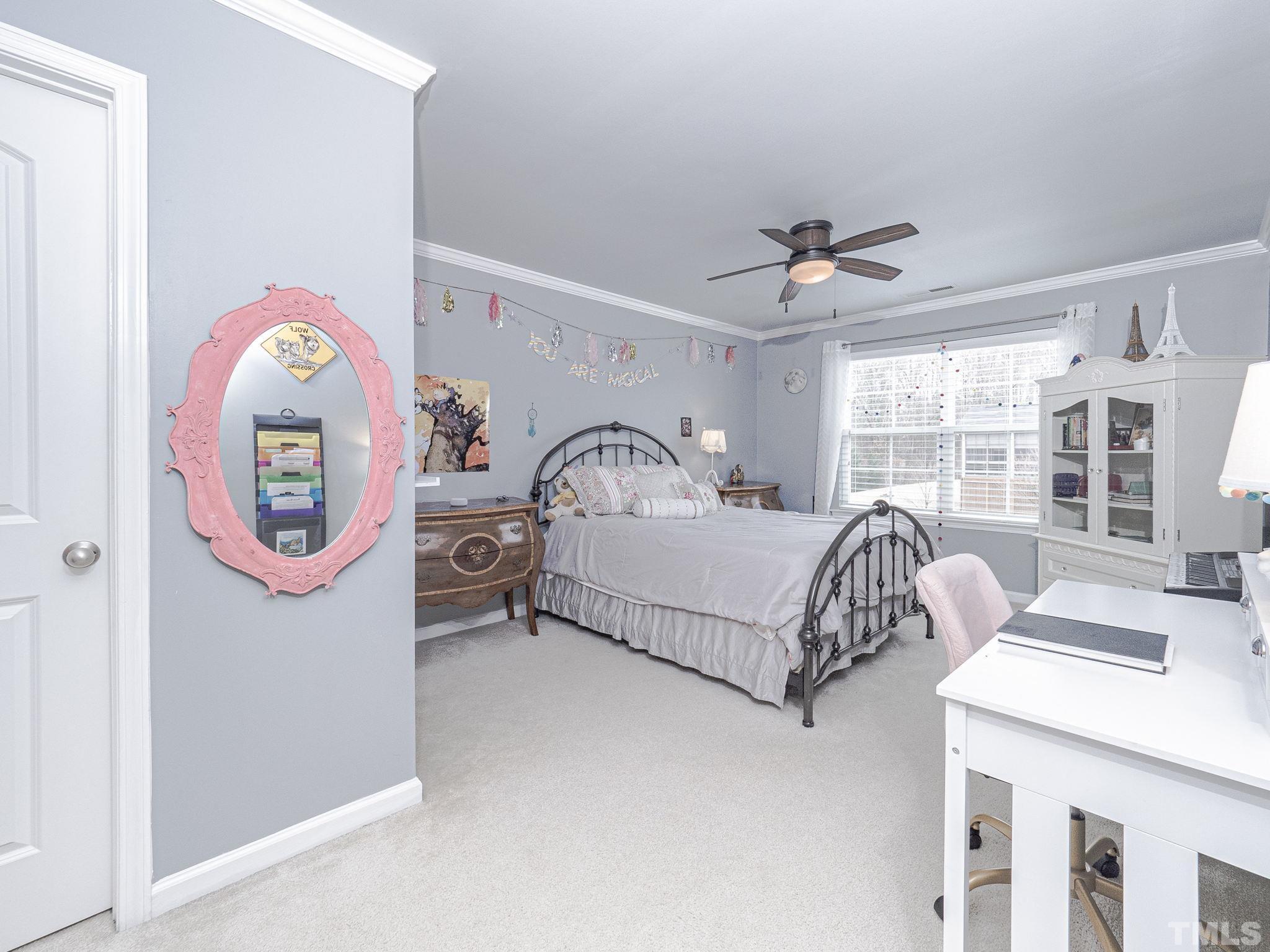 1990 Mostyn Lane Apex, NC 27502 - Photo 29 of 41 a bedroom with a bed a dresser and a window
